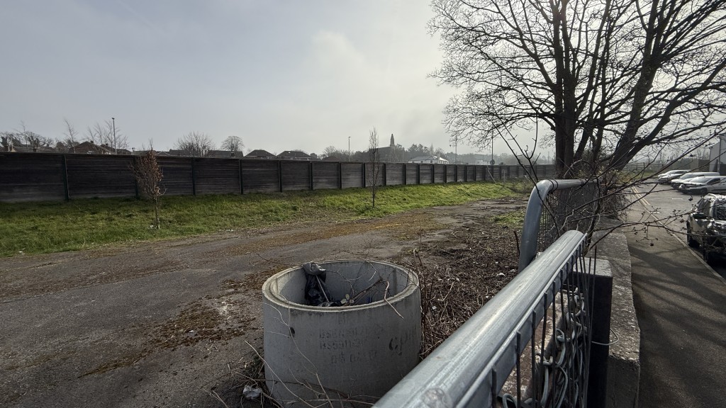 Lot: 24 - OPEN YARD AND LAND OFF KING EDWARD ROAD WITH POTENTIAL - External image of site over fence looking south